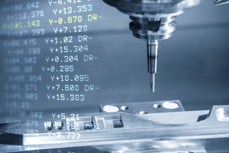 The abstract scene CNC milling machine with the G-code data background.The machining center cutting the mold parts with solid ball endmill tool.の写真素材