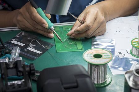 The  soldering operator repair the electronics circuit board. The electronic circuit board soldering...