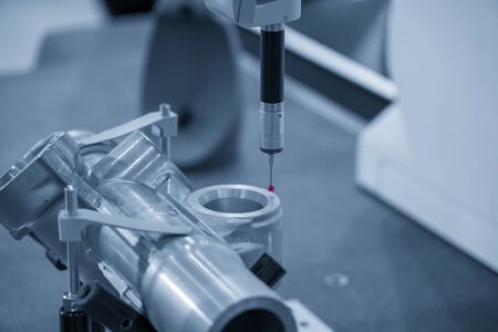 The CMM , coordinate measuring machine measure the aluminium parts with the touching probe. The automotive parts quality control concept.の写真素材