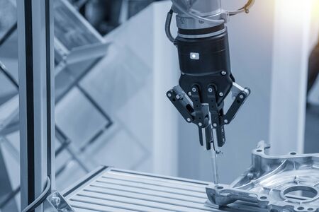 The robotic arm assembly the pin in the aluminium casting part. The hi-technology manufacturing...