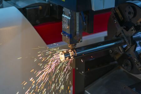 The fiber laser cutting machine cutting the steel tube .The sheet metal processing by laser cutting machine.の写真素材