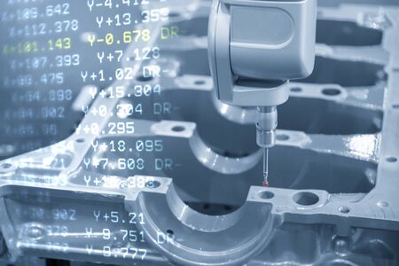 The abstract scene multi-axis CMM machine and the G-code data   while measure the aluminium cylinder block  parts.Automotive parts quality control process with multi-axis Coordinate Measuring Machine.の写真素材