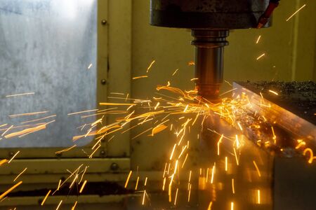 The CNC milling machine rough cutting the forging mould parts by indexable radius endmill tools with bad cutting condition. The burning cutting chip by bad cutting condition in machining center.の写真素材