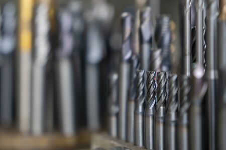 The various type  cutting tools of CNC machine on the stock shelf  in the light blue scene. The collection of CNC cutting tool , solid ball ,bull or radius ,flat or square, tapping endmill tools.の写真素材