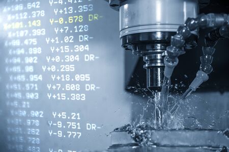 The abstract scene of the G-code data  and the CNC milling machine cutting the forging mold parts with solid ball endmill tools. Hi-precision  mould and die production process by machining center.の写真素材