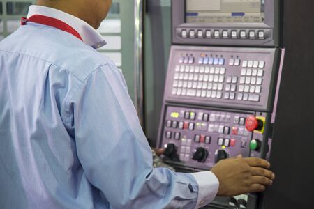 The skill operator working by operate with the control panel of CNC milling machine. The operation...