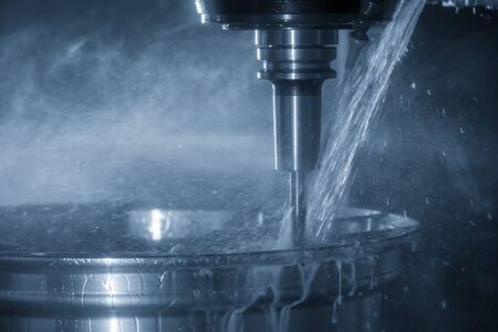 The CNC milling center cutting the alloy wheel by solid ball endmill tool with coolant method. The magnesium alloy wheel manufacturing process by machining centre.の写真素材