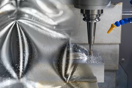 The abstract scene of CNC milling machine rough cutting  the injection mold parts by solid endmill tools. The mold and die manufacturing process by machining center with the solid endmill tools.の写真素材