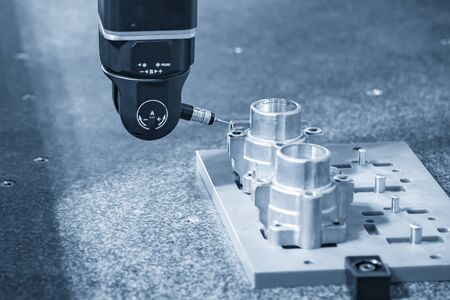 The multi-axis,CMM probe  measure dimension of the aluminium casting parts .The quality control in automotive  parts manufacturing process by multi-axis CMM machine.の写真素材