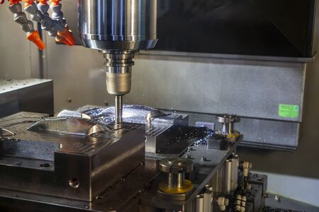 The CNC milling machine rough cutting  the injection mold parts by indexable  endmill tools. The mold and die manufacturing process by machining center with the solid endmill tools.の写真素材