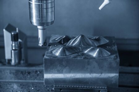 The CNC milling machine rough cutting  the injection mold parts by indexable  endmill tools. The mold and die manufacturing process by machining center with the solid endmill tools.の写真素材
