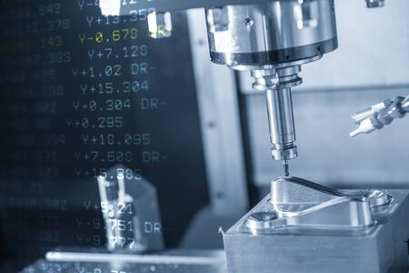 The abstract scene of CNC  milling machine and NC data background  cutting at the mold parts by...