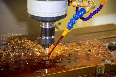 The CNC milling machine cutting the tire mold parts with liquid oil coolant method. The mold and die...