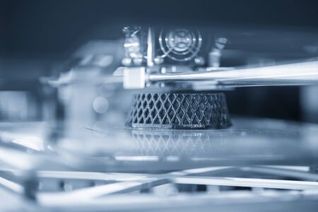 Close-up scene of 3D model printer operation . Hi-technology rapid prototype for design processing by 3D printing machine.の写真素材