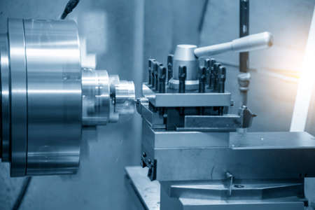 The operation of lathe machine cutting the brass shaft parts with the cutting tools. The...