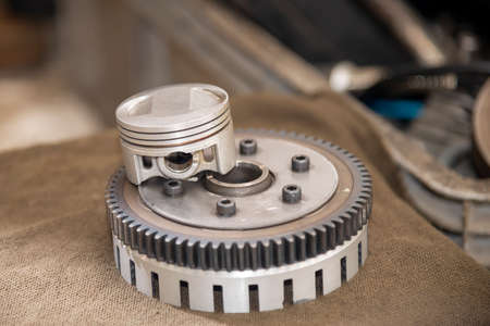 The  part of piston and flywheel  of motorcycle engine. The motorbike parts repairing process.