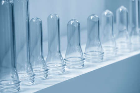 The pile of tube preform shape plastic bottles . The preform shape material from injection process.