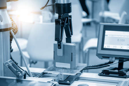The hi-technology  material handling process by robotic system. The automatic pneumatic robotic arm picking the container box in production line.の写真素材