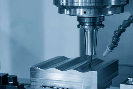 The  CNC  milling machine cutting  the mold parts by solid ball  end-mill tool. The hi-precision mold and die manufacturing concept by machining center.の写真素材