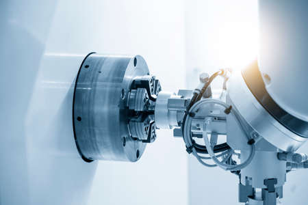 The robotics arm gripping the metal part from CNC lathe machine. The hi-technology  autonomous...