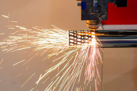 The fiber laser cutting machine cutting the stainless steel tube control by CNC program. The sheet...