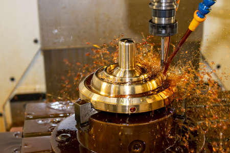 The CNC milling machine cutting the  shell mold parts with oil coolant method. The mold and die manufacturing process by CNC machining center.の写真素材
