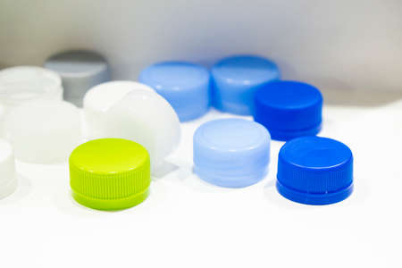 The multi-colors plastic bottle caps on the white background. The plastic products manufacturing concept.の写真素材