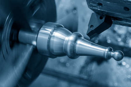 The  CNC lathe machine forming cut the metal shaft parts. The hi-technology metal working processing by CNC turning machine .の写真素材