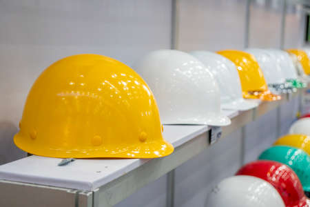 The group of plastic helmet on the shelf. The abstract scene of civil engineer.の写真素材