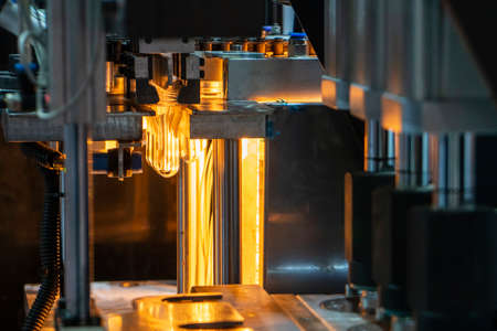 The operation of plastic bottle blowing machine. The drinking water bottle manufacturing process by blow mold machine.の写真素材