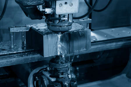 The wire EDM machine cutting the insert mold parts. The die insert cutting process by wire cut...