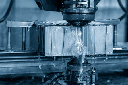 The wire EDM machine cutting the mold insert parts. The die insert cutting process by wire cut machine control by CNC program.の写真素材