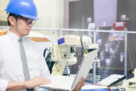 The engineer use notebook setup program for robotic in material handling system .The hi-technology...