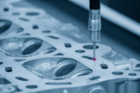 The  CMM machine measuring the cylinder head parts . The quality control of automotive parts with...