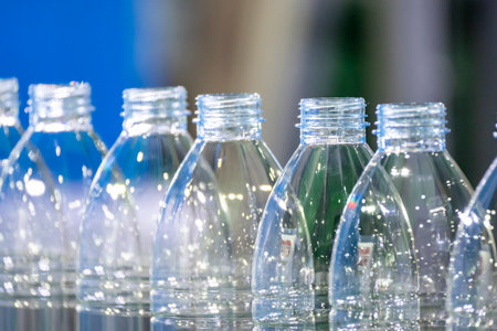 The empty PET bottles  on the conveyor belt for filling process in the drinking water factory. The...