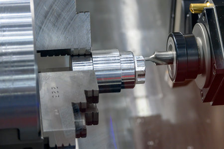 The multi-tasking CNC lathe machine  chamfer cutting the metal shaft parts by milling turret. The...