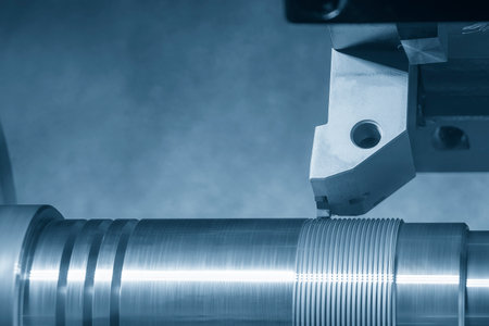 The CNC lathe machine thread cutting at the metal shaft parts. The hi-technology metal working...