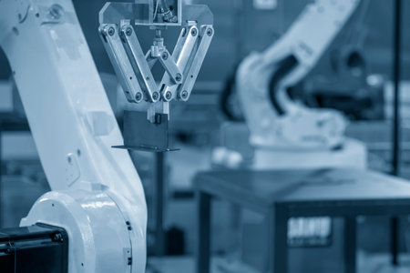 The hi-technology  material handling process by robotic system in turning machine. The automatic  robotic arm gripping the metal parts.の写真素材