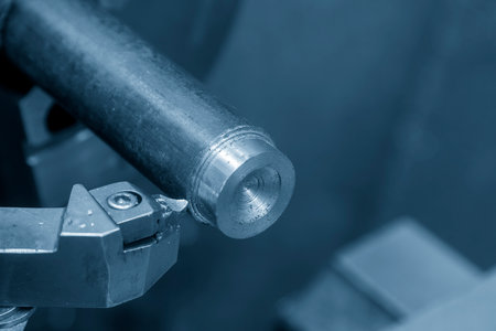 Close up scene the lathe machine finish cut the metal shaft parts by insert tools. The metalworking...