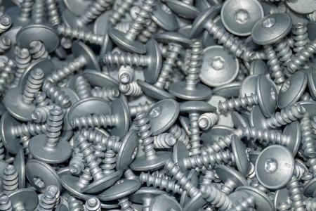 The pile of hexagon socket head screw in the container box. The special screws for construction...