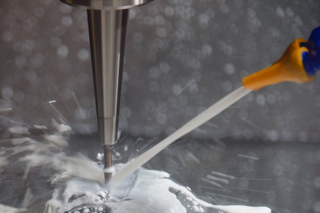 The CNC milling machine cutting the  mold parts with water base coolant method . The mold and die manufacturing process by machining center with the solid ball endmill tools.の写真素材