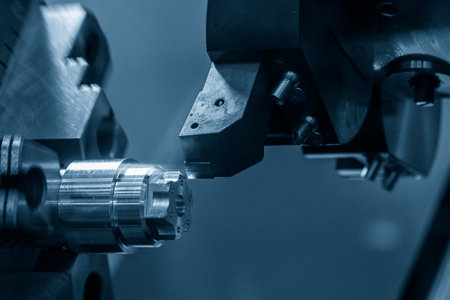 The  CNC lathe machine forming  cutting the metal shaft parts. The hi-technology metal working processing by CNC turning machine .の写真素材