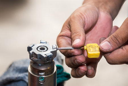 The chip insert replacement process by machine operator.  Machine operator change the chip insert on...
