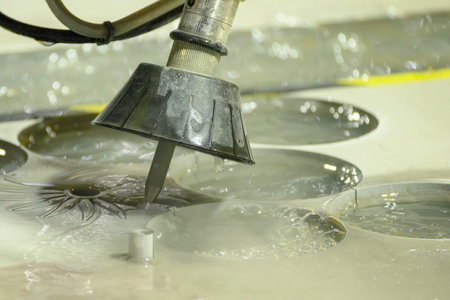 The multi-axis abrasive waterjet cutting machine cutting the metal plate. The high technology sheet...