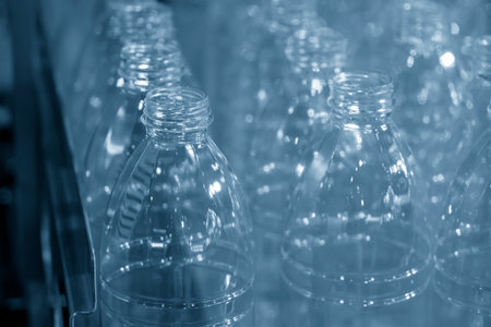The  empty drinking water bottles  on the conveyor belt for filling process. The hi-technology of drinking water manufacturing process.の写真素材