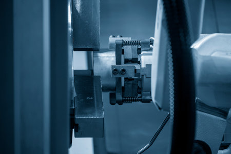 The automatic  robotic arm gripping the metal parts from CNC lathe machine. The hi-technology ...