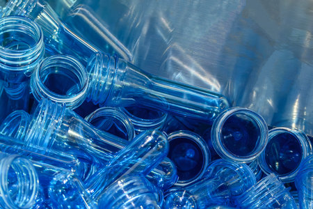 Close up scene pile of preform shape of PET bottle products. The raw material for plastic bottle...