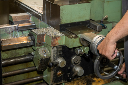 The machine operator working with lathe machine. The metalworking process by turning machine.の写真素材