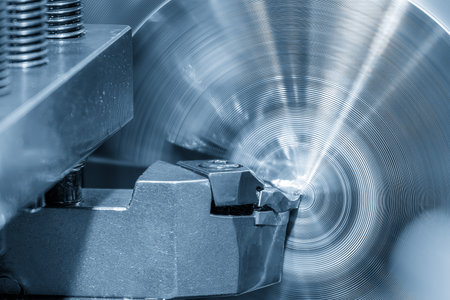 Closeup scene the lathe machine finish cut the metal parts in the light blue scene. The metalworking process by turning machine.の写真素材