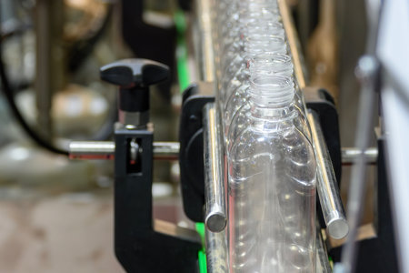 The  empty drinking water bottles  on the conveyor belt for filling process. The hi-technology of...